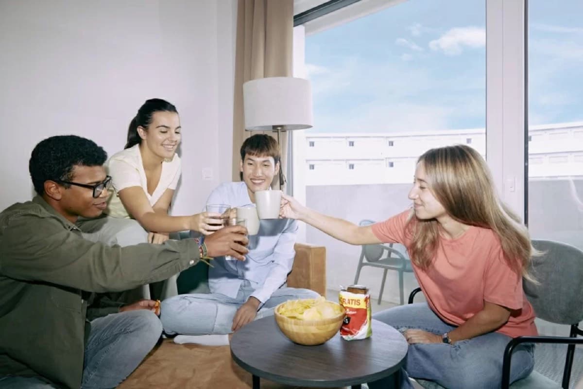 International Erasmus participants cheers-ing in a co-living common room