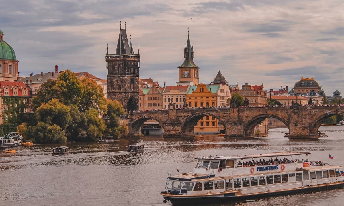 Charles Bridge and the Prague skyline at dusk over the Vltava river