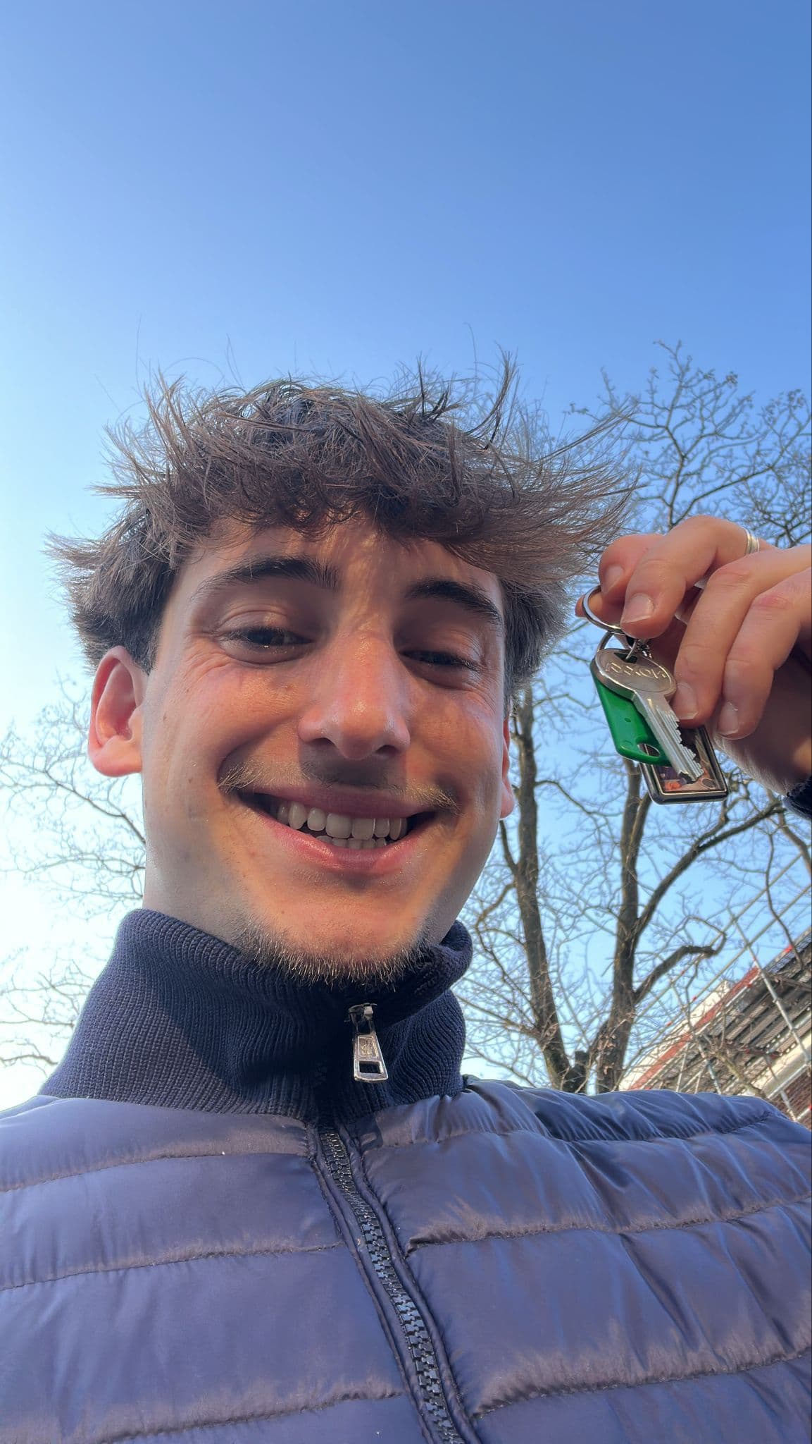 Student holding keys to their new home